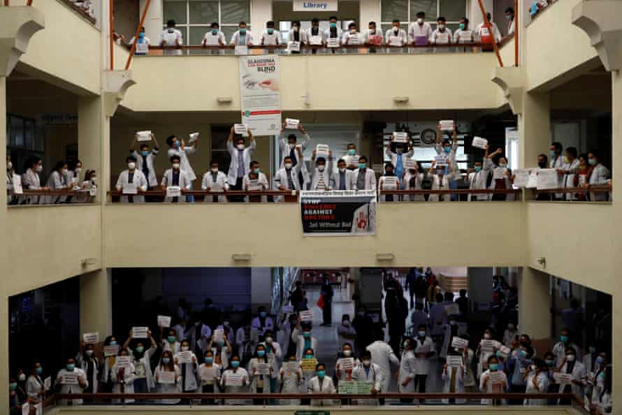 Doctors holding placards protest against assaults on doctors at Nepal Medical College and Teaching Hospital during the lockdown, in Kathmandu on 31 May.